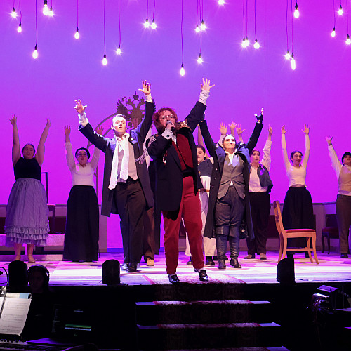 Actors perform on stage