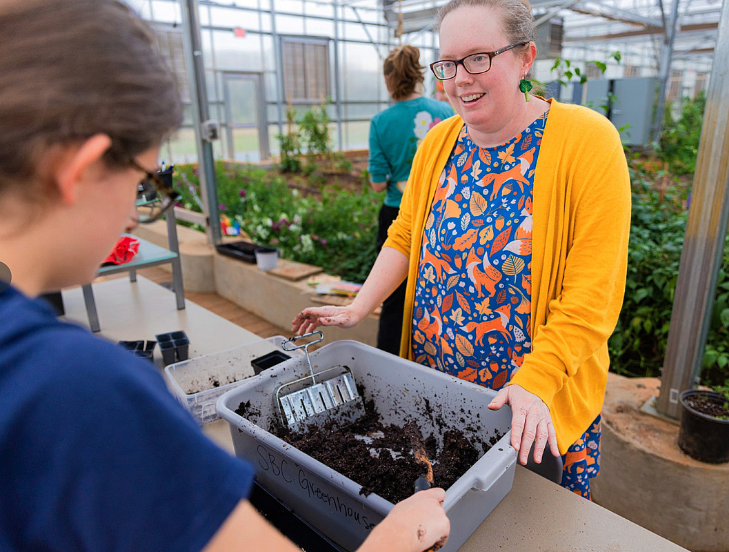 Prof. Lisa Powell in the campus greenhouse.