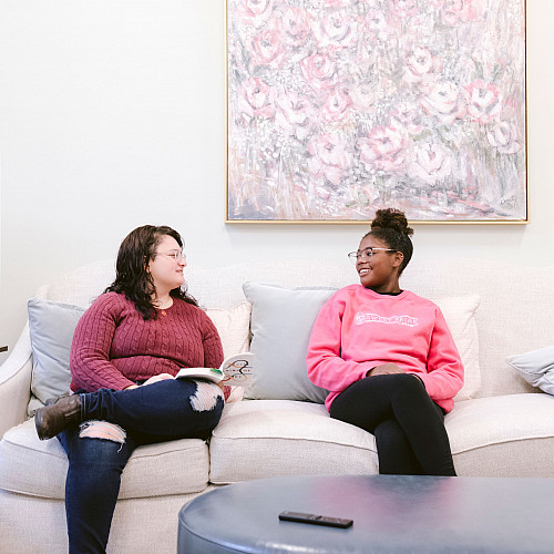 Girls talking and sitting on couch