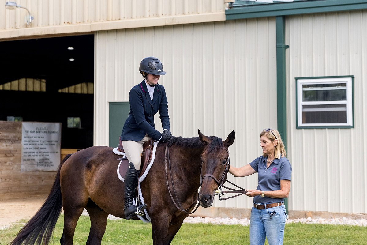 Associate Head of the Riding Program Elizabeth Lizzie Fisch works with a student.