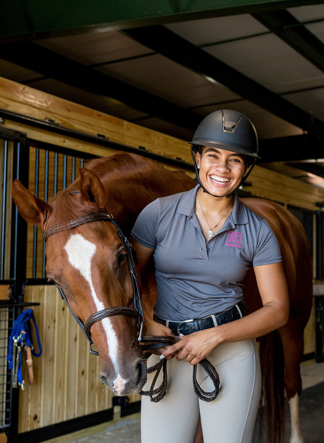 Student with horse in stables