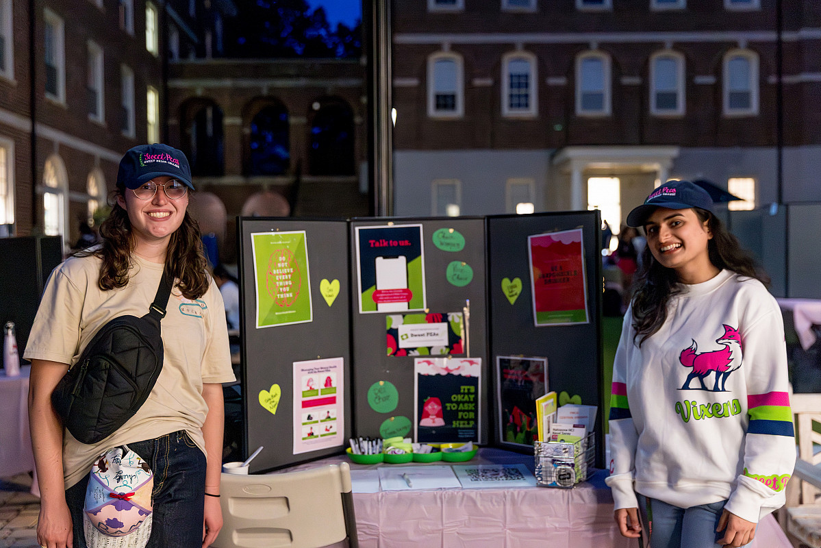Students posing with poster